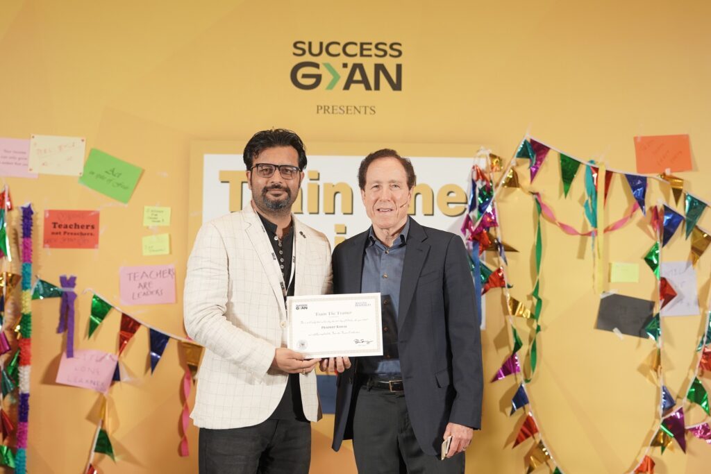 Pradeep Rawal receiving the Train the Trainer certificate from Blair Singer